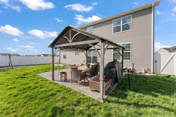 a front view of a house with garden and patio