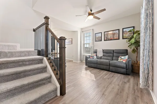 a living room with furniture and a wooden floor