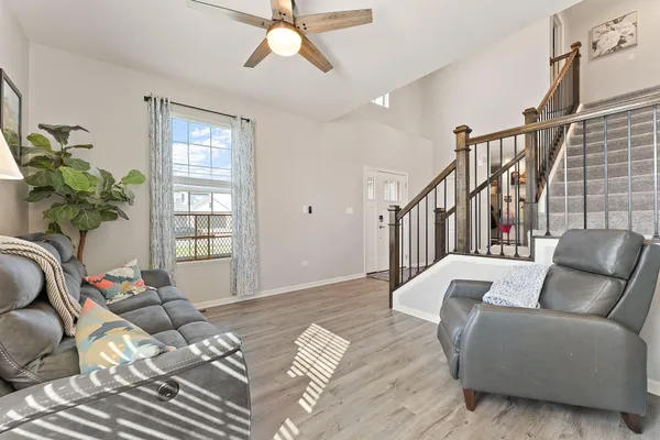 a living room with furniture and wooden floor