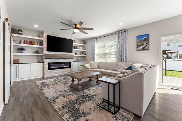 a living room with furniture flat screen tv and window