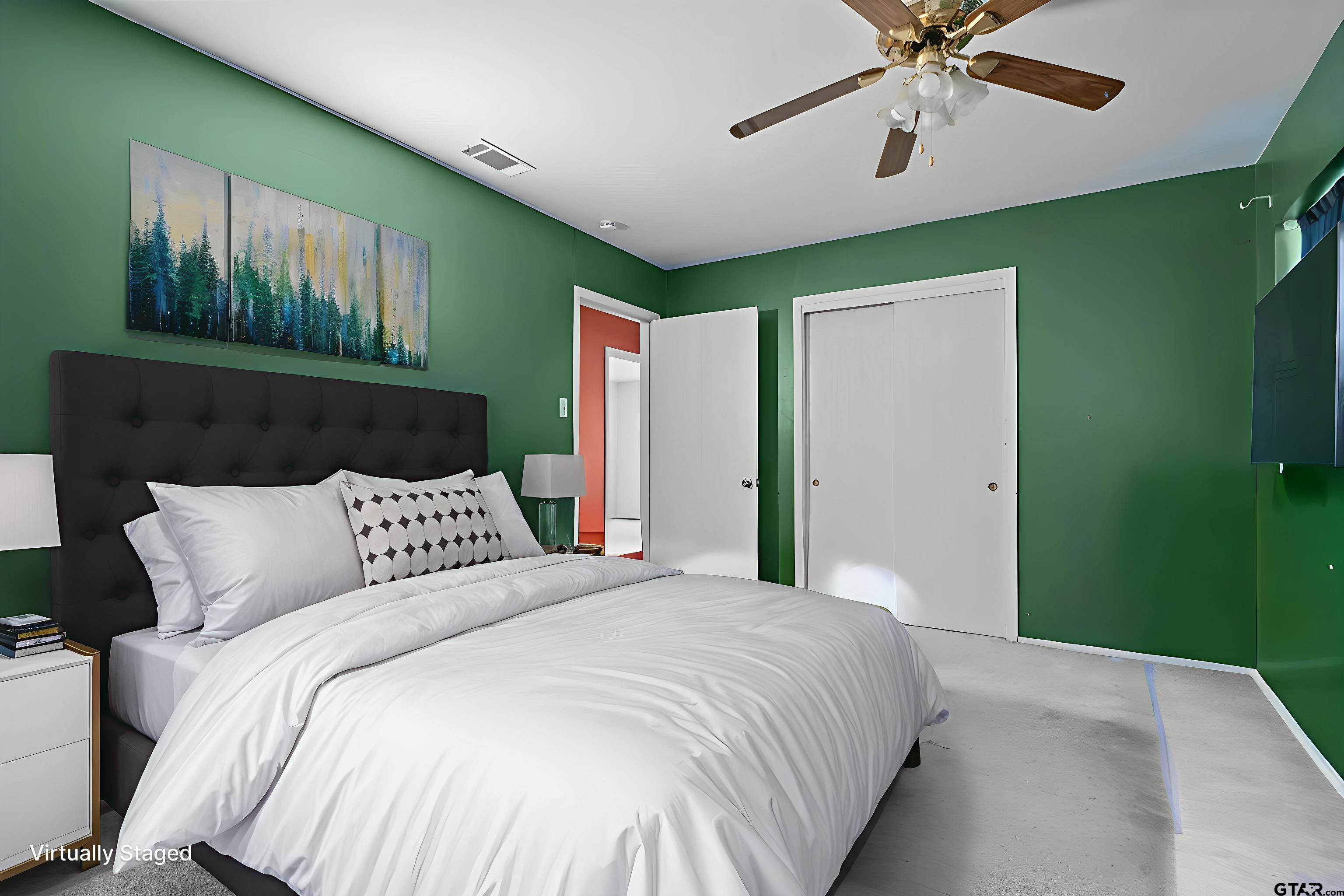 2002 Faulkner Street Tyler, TX 75701 - Photo 14 of 32 a bedroom with a large bed and a chandelier