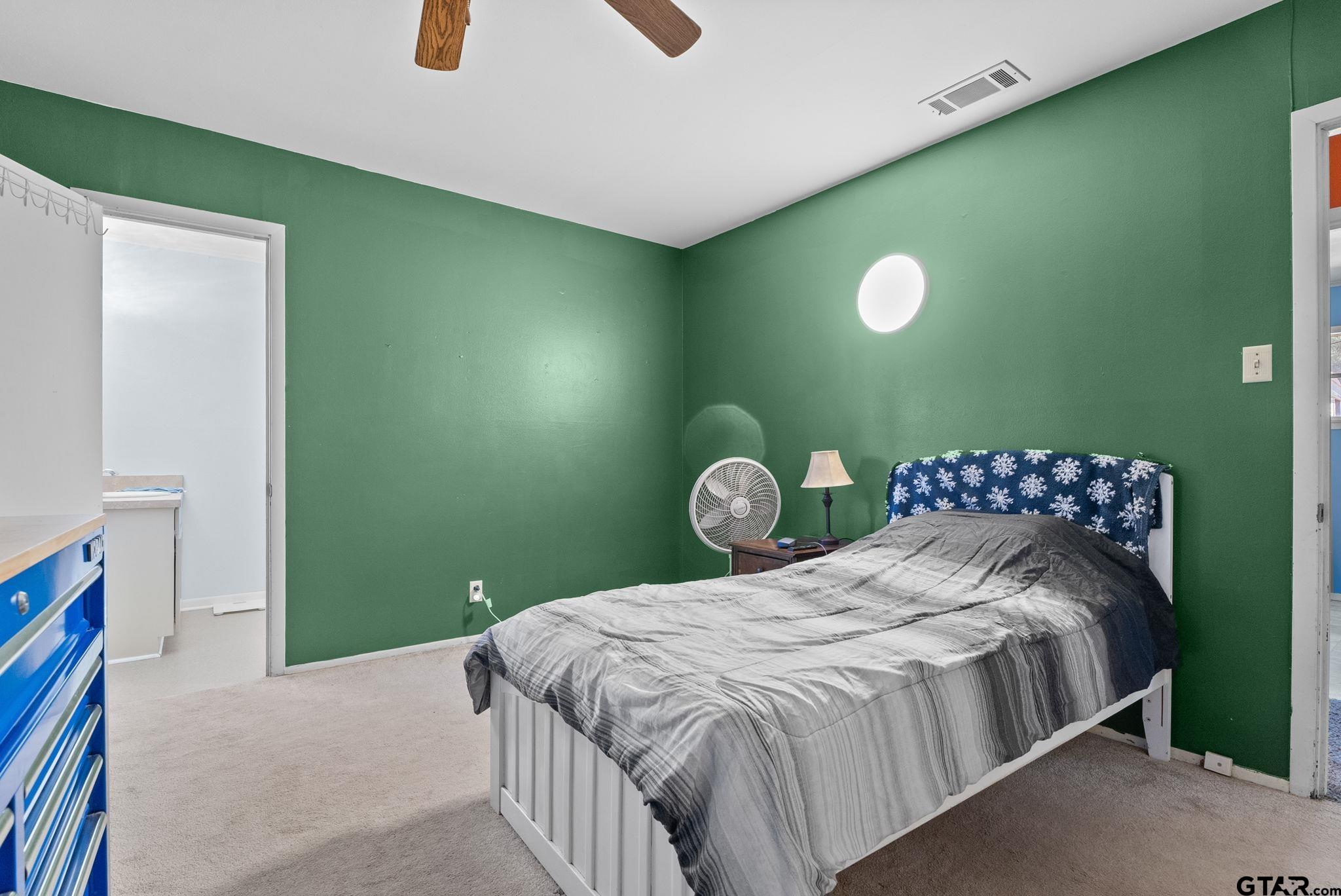 2002 Faulkner Street Tyler, TX 75701 - Photo 15 of 32 a bedroom with a bed and blue wall