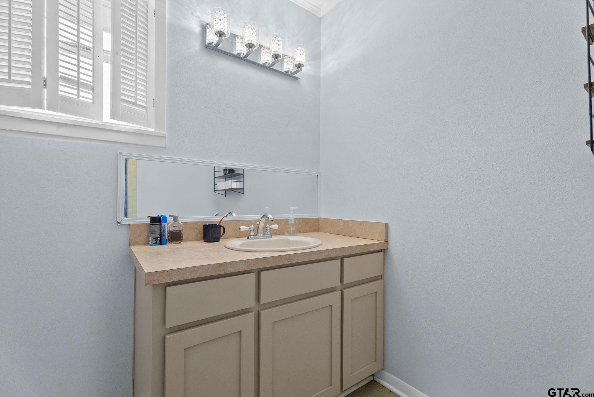 2002 Faulkner Street Tyler, TX 75701 - Photo 16 of 32 a bathroom with a sink and a mirror
