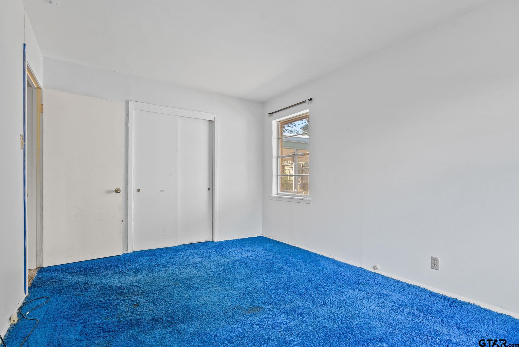 2002 Faulkner Street Tyler, TX 75701 - Photo 19 of 32 a view of an empty room with wooden floor and a window