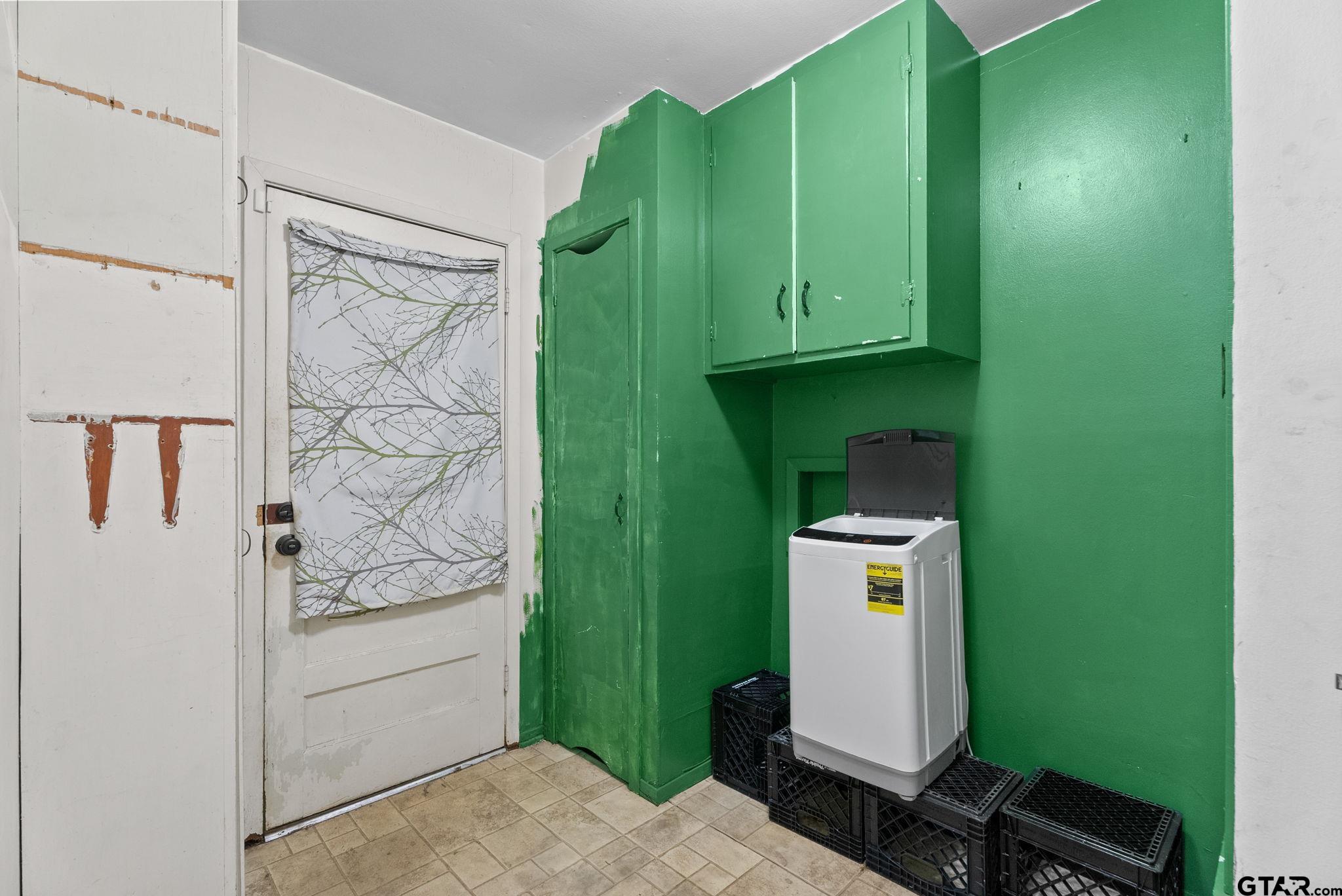 2002 Faulkner Street Tyler, TX 75701 - Photo 27 of 32 a room with washing machine and a chair