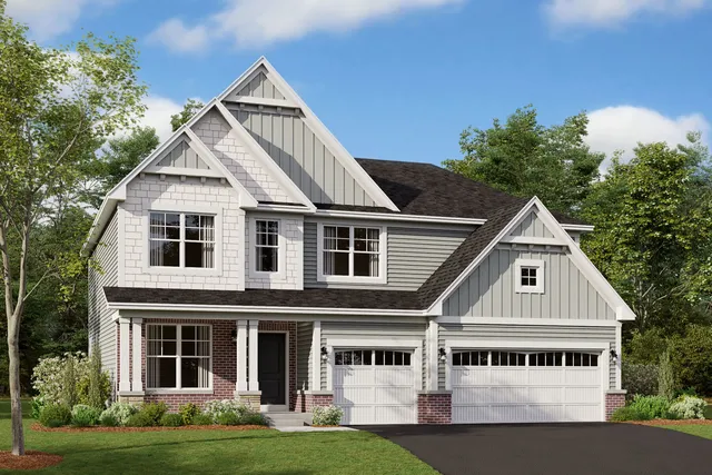 a view of white house with a big yard and potted plants in front of the house