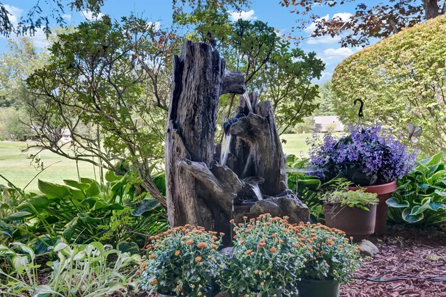 a dining room with furniture a chandelier and window