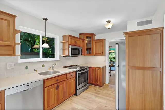 a bathroom with a granite countertop sink mirror vanity and toilet