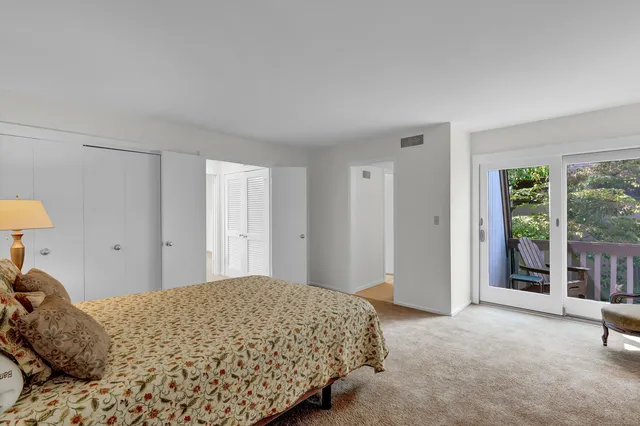 a en suite bathroom with a granite countertop sink and a mirror