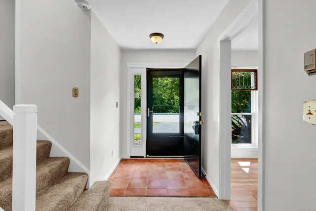 a view of a livingroom with a fireplace and a window