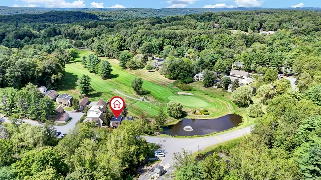 an aerial view of a house with a yard and lake view