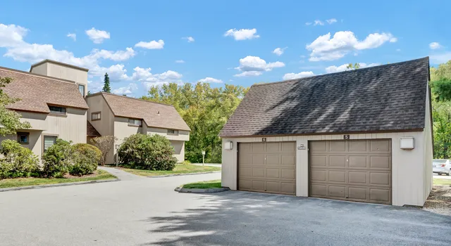 an aerial view of a house with garden space and street view