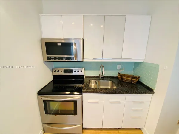 a kitchen with a stove and a microwave