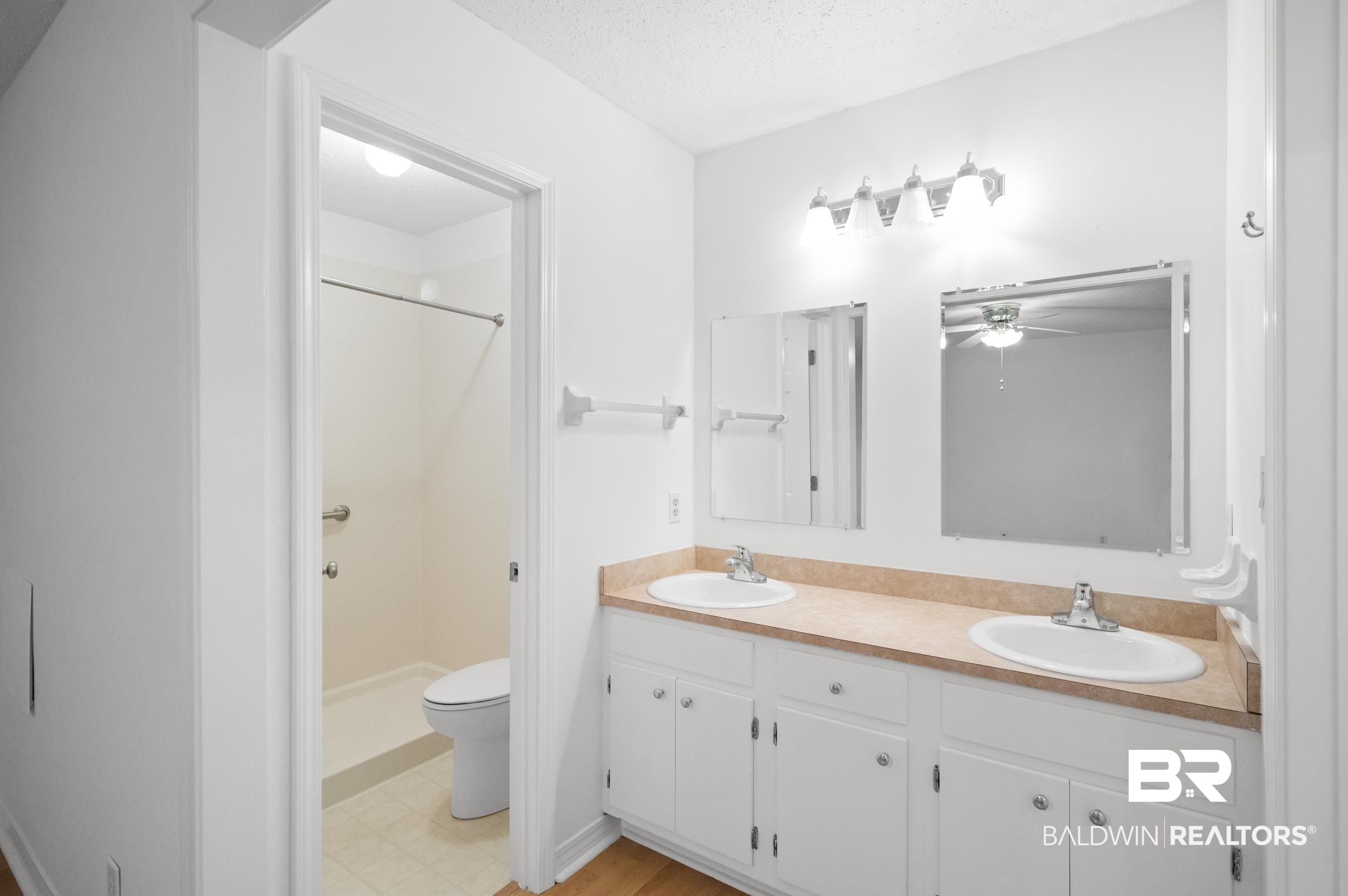 128 Dunbar Loop Daphne, AL 36526 - Photo 16 of 39 Bathroom featuring toilet, vanity, a textured ceiling, a shower, and ceiling fan