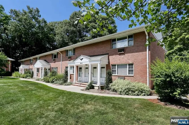 a front view of a house with a yard table and chairs