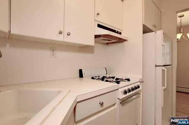 a kitchen with a white cabinets and white appliances