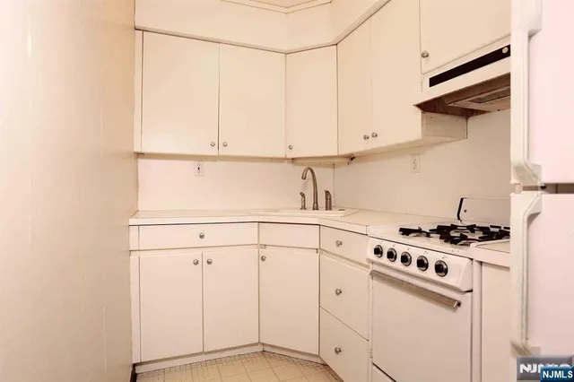 a kitchen with cabinets and appliances