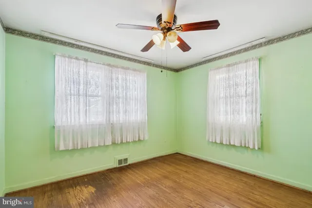 a view of room with window and ceiling fan