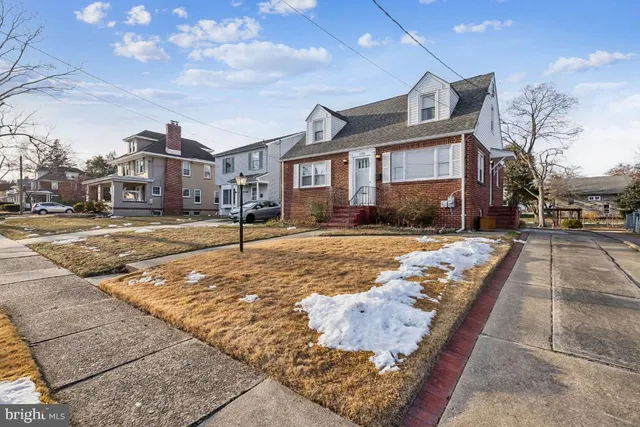 a view of a big house with a yard