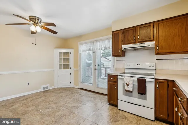 a kitchen with a stove oven and cabinets