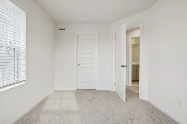 a white bath tub sitting next to a white toilet and vanity