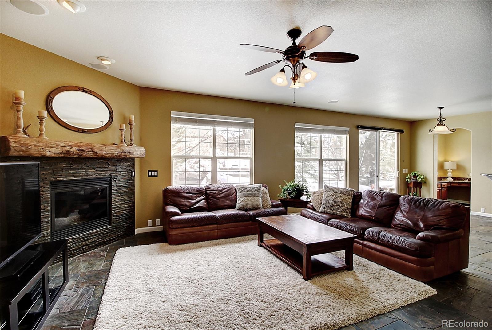 16330 Avalanche Run Broomfield, CO 80023 - Photo 11 of 39 a living room with furniture a window and a fireplace