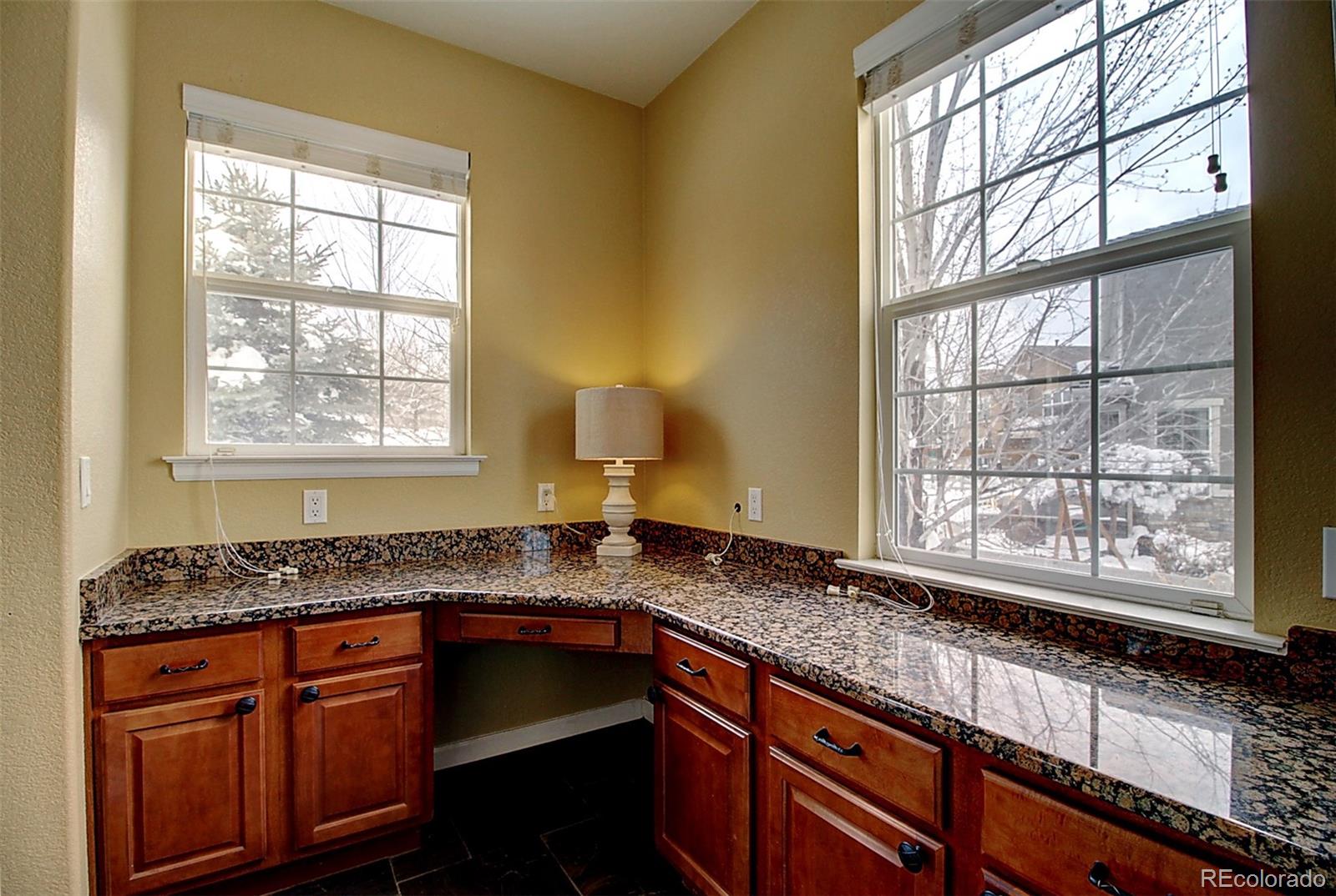 16330 Avalanche Run Broomfield, CO 80023 - Photo 13 of 39 a kitchen with granite countertop stainless steel appliances a sink stove and cabinets