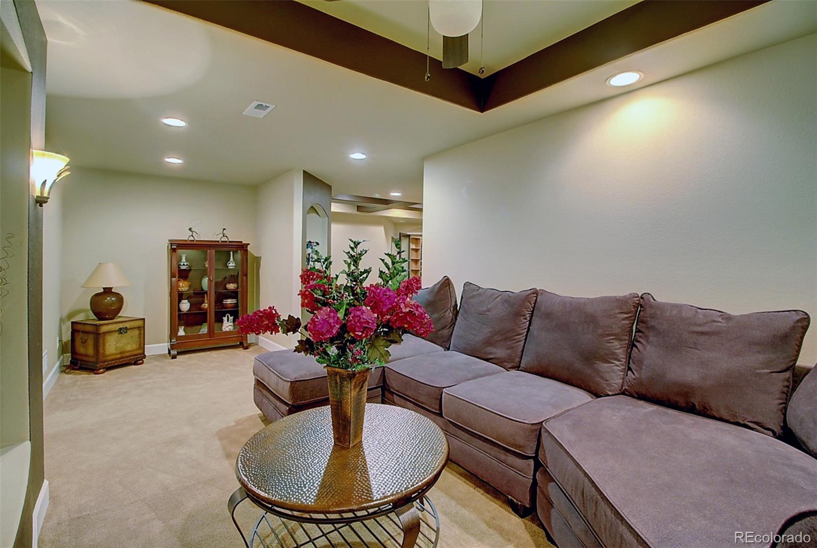 16330 Avalanche Run Broomfield, CO 80023 - Photo 27 of 39 a living room with furniture flowerpot and a chandelier