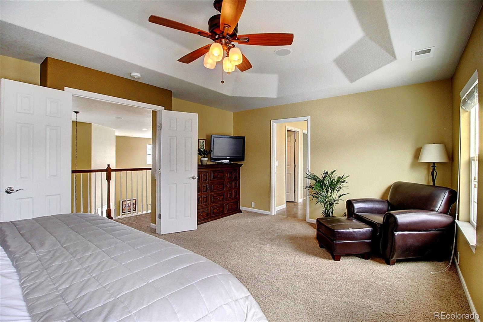 16330 Avalanche Run Broomfield, CO 80023 - Photo 30 of 39 a bedroom with a bed dresser and a large window