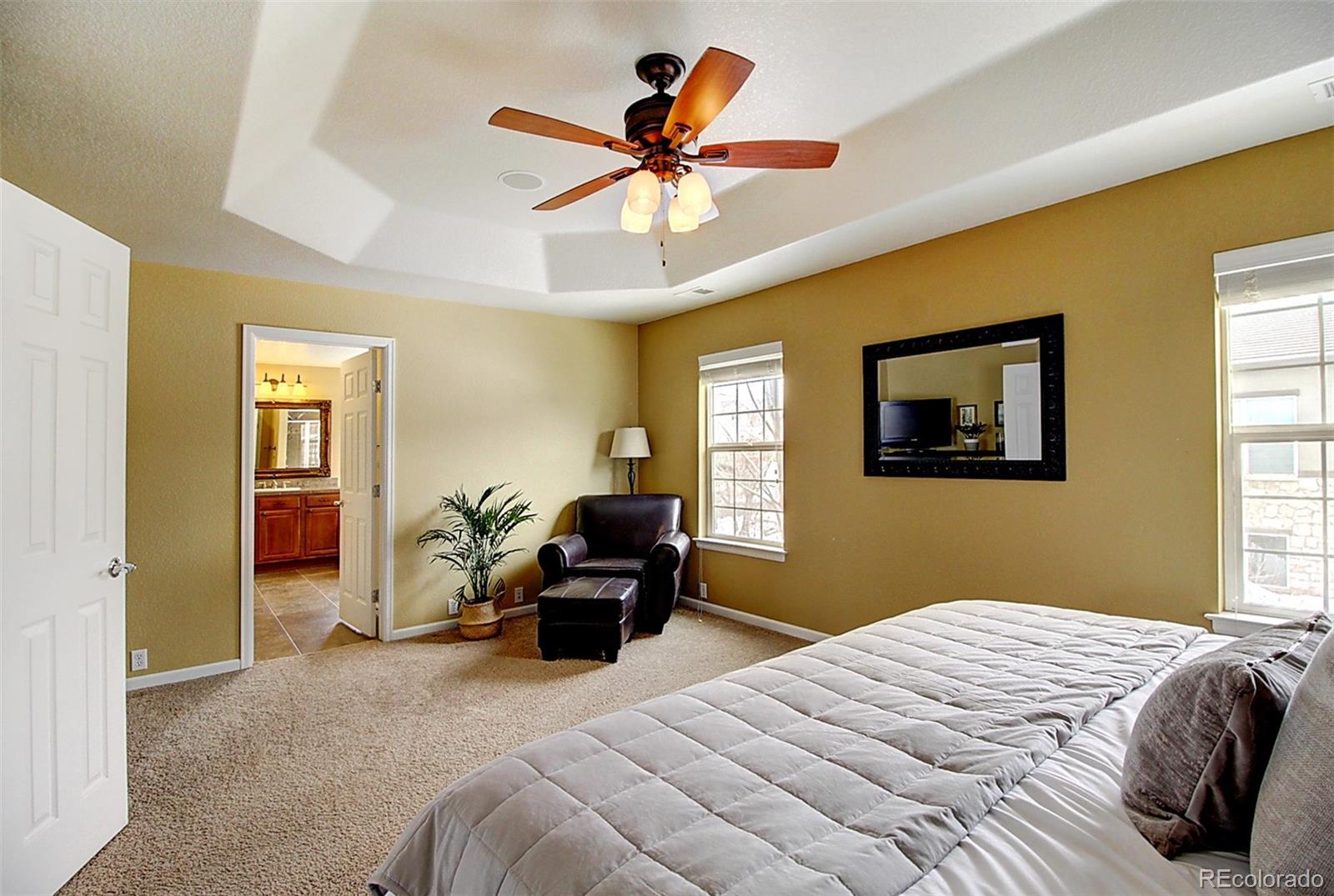 16330 Avalanche Run Broomfield, CO 80023 - Photo 31 of 39 a bedroom with a bed and a chandelier