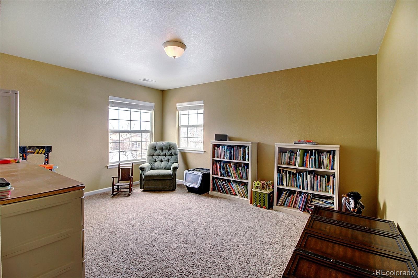 16330 Avalanche Run Broomfield, CO 80023 - Photo 38 of 39 a living room with furniture and a book shelf