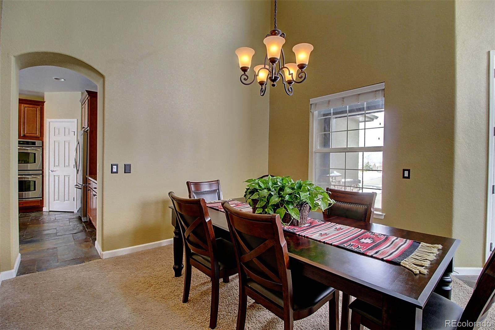 16330 Avalanche Run Broomfield, CO 80023 - Photo 5 of 39 a view of a dining room with furniture and chandelier
