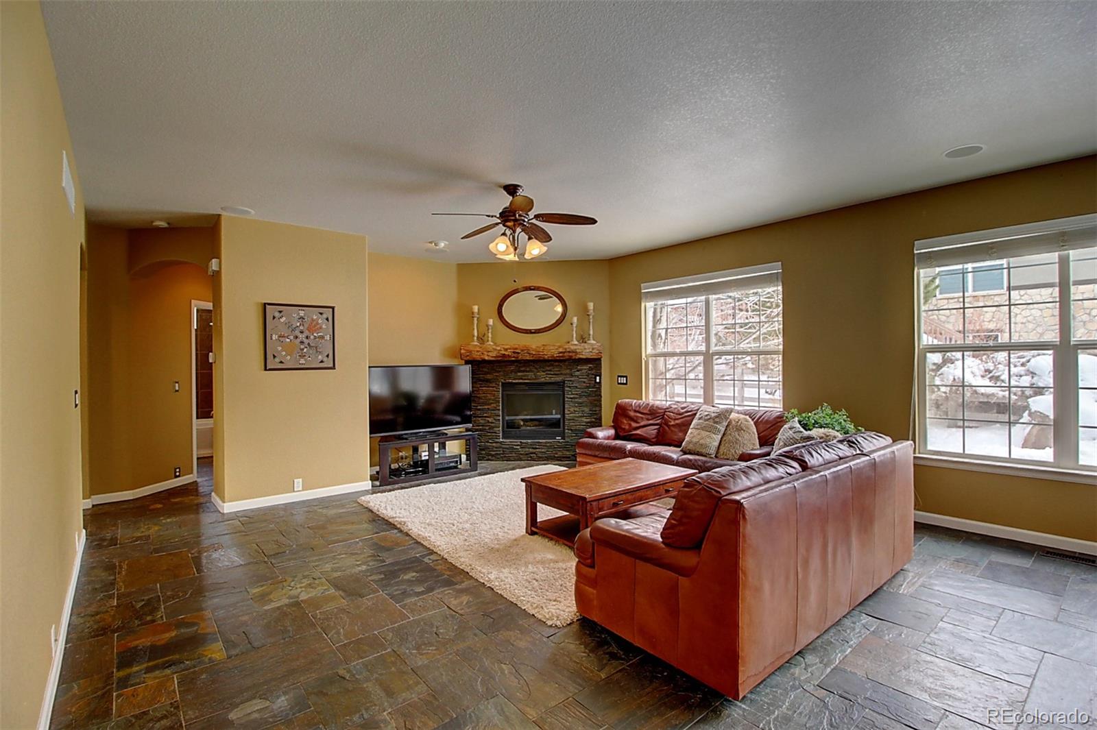 16330 Avalanche Run Broomfield, CO 80023 - Photo 10 of 39 a living room with furniture and a fireplace