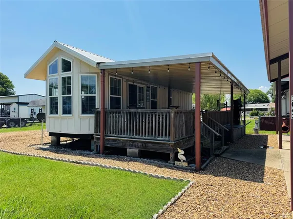a view of a house with a yard and furniture