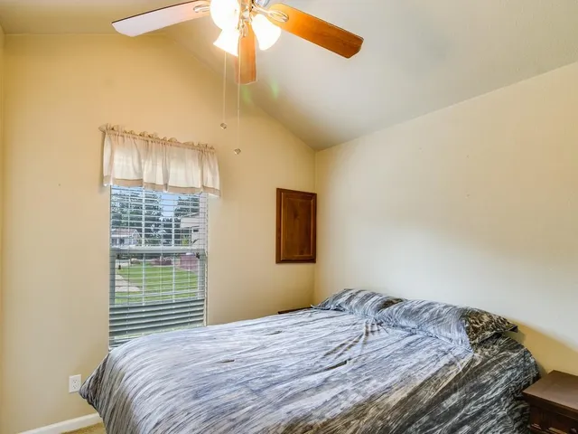 a bedroom with a bed and a window