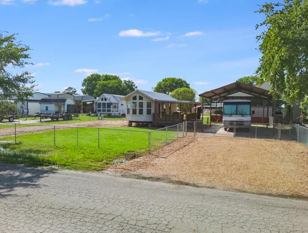 a view of a house with a yard and plants