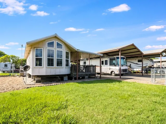 a front view of a house with a yard table and chairs