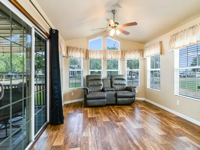 a living room with furniture and a large window