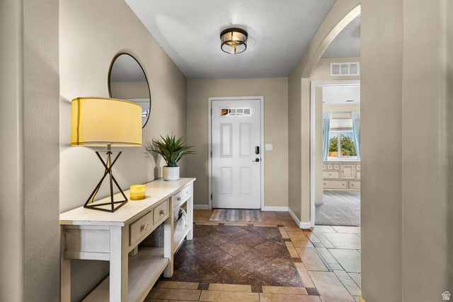225 Falcon Court Ivins, UT 84738 - Photo 3 of 47 Entryway with inlaid floor details, tile patterned flooring, and arched walkways