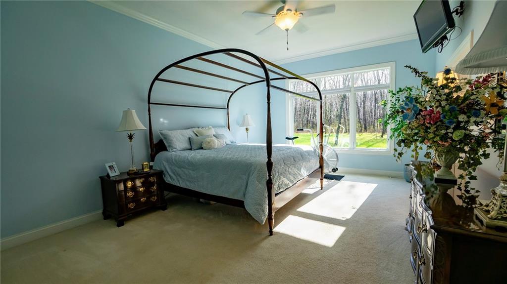 375 Old Plank Road Butler, PA 16002 - Photo 14 of 25 a bedroom with a bed and a chandelier