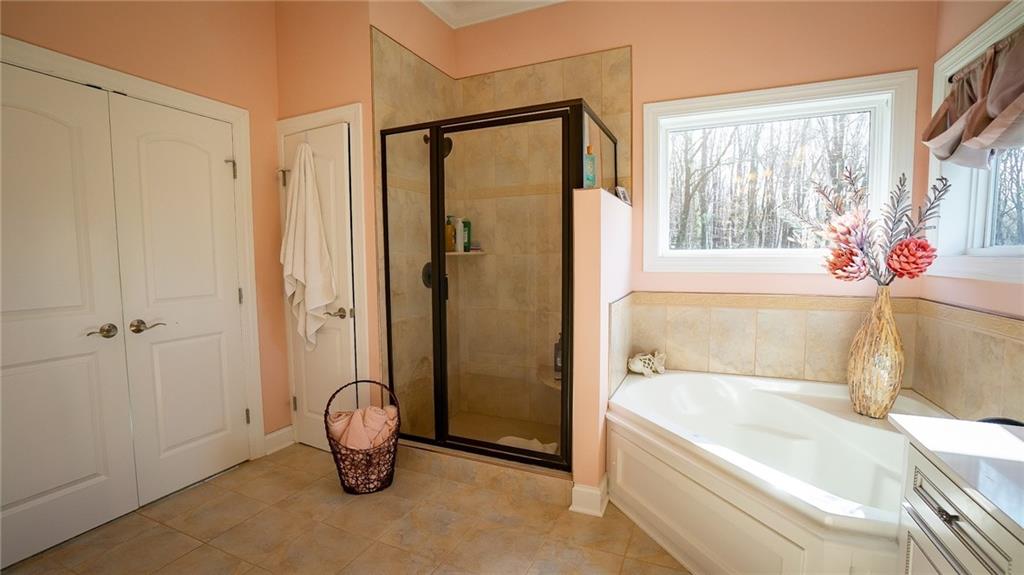 375 Old Plank Road Butler, PA 16002 - Photo 16 of 25 a bathroom with a tub and shower