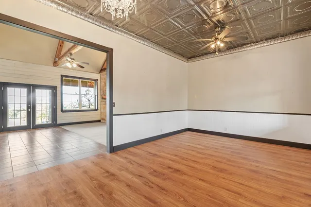 a view of a big room with wooden cabinets and windows