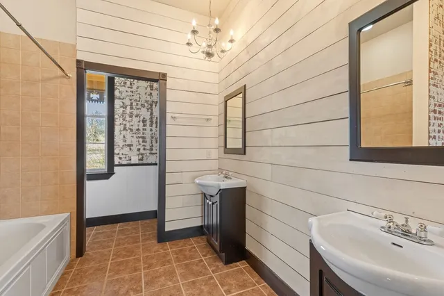 an empty room with windows and ceiling fan