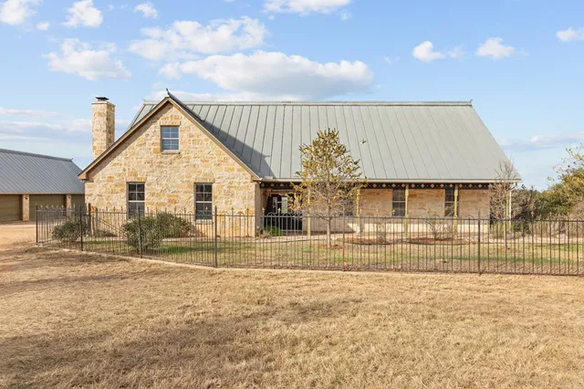 a view of house with backyard and kitchen