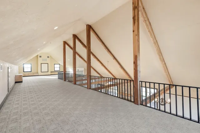 an aerial view of a house with a yard and ocean view