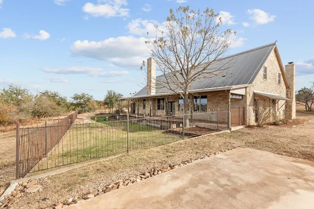 a view of a house with pool and sitting area