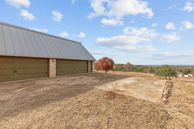 a view of a house with a yard and garage