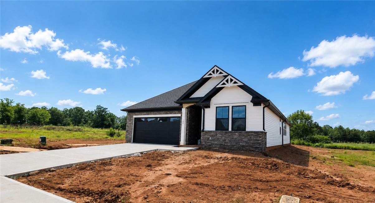 188 Tiger Lily Drive Anderson, SC 29621 - Photo 2 of 25 A newly constructed residence features modern siding and a sleek garage door, poised amidst natural surroundings.