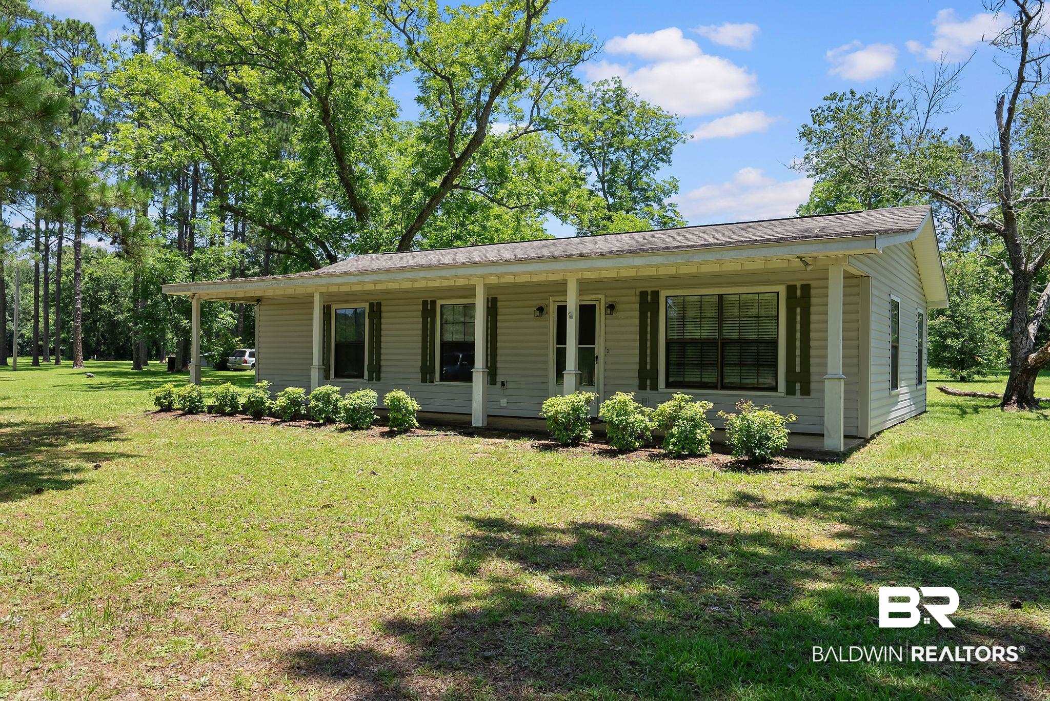 20540 Lacey Road Silverhill, AL 36576 - Photo 3 of 40 Ranch-style residence featuring light-colored siding and a covered front porch supported by square columns