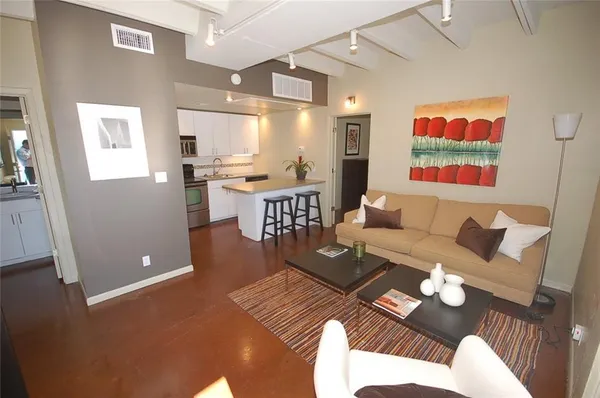 a spacious bedroom with a bed and a chair